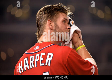 Washington Nationals' Bryce Harper wipes his face as he stands by second  base during the eighth inning of a baseball game against the Baltimore  Orioles, Monday, Aug. 22, 2016, in Baltimore. The