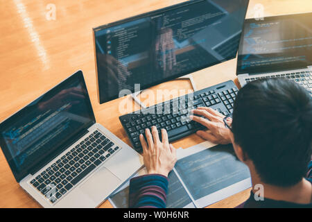 Professional Development programmer working in programming website a software and coding technology, writing codes and data code, Programming with HTM Stock Photo