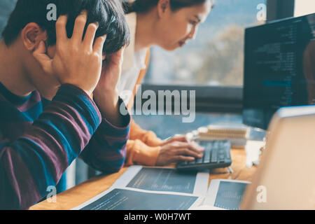 Professional Development programmer cooperating meeting and brainstorming and programming website working in a software and coding technology, writing Stock Photo