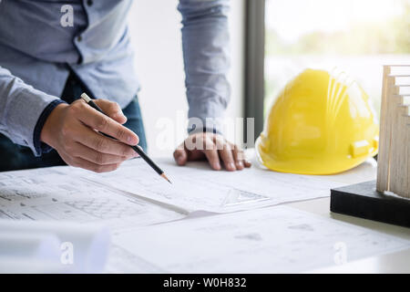 Construction engineering or architect hands working on blueprint inspection in workplace, while checking information drawing and sketching for archite Stock Photo