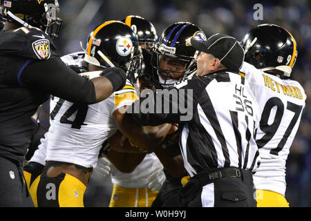 A referee breaks up a fight between the Baltimore Ravens and Pittsburgh  Steelers in the first quarter at M&T Bank Stadium in Baltimore, Maryland,  November 28, 2013. Tucker kicked 5 field goals