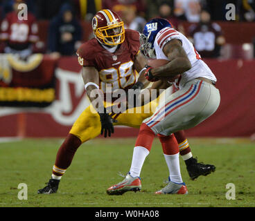 New York Giants free safety Will Hill strips the ball from Washington Redskins wide receiver Pierre Garcon to end the Redskins final drive of the game, in the fourth quarter  at FedEx Field in Landover, Maryland, December 1, 2013. The Giants defeated the Redskins 24-17.  UPI/Kevin Dietsch Stock Photo