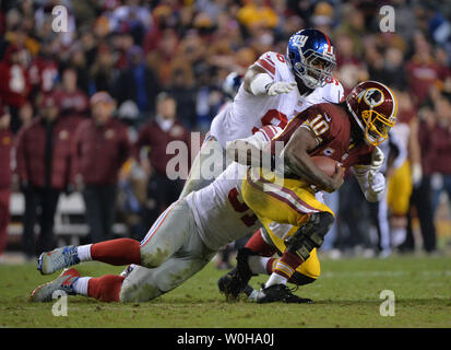New York Giants defensive tackle Johnathan Hankins (96) and defensive end Justin Tuck (91) sack Washington Redskins quarterback Robert Griffin III in the fourth quarter at FedEx Field in Landover, Maryland, December 1, 2013. The Giants defeated the Redskins 24-17.  UPI/Kevin Dietsch Stock Photo