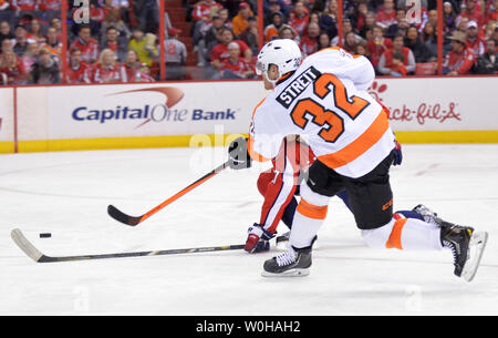 Philadelphia Flyers Mark Streit shoots for a goal against the Washington Capitals during the second period at the Verizon Center in Washington, D.C. on December 15, 2013.  UPI/Kevin Dietsch Stock Photo