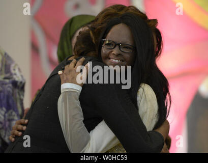 First lady Michelle Obama hugs Laxmi of India, an acid attack victim and advocate on behalf of acid attack victims, during an event to honor the recipients of the International Women of Courage Award at the U.S. Department of State, March 4, 2014, in Washington D.C.  The International Women of Courage Award annually recognizes women around the globe who have shown exceptional courage and leadership in advocating for womenÕs rights and empowerment, often at great personal risk.  UPI/Molly Riley Stock Photo