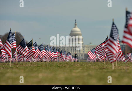 Some of the 1,892 American flags are seen on the National Mall placed by The Iraq and Afghanistan Veterans of America, each flag represents one of the 1,892 veterans and service members who have committed suicide this year, in Washington, D.C., March 27, 2014. The memorial is part of the 'We've Got Your Back: IAVA's Campaign to Combat Suicide  UPI/Kevin Dietsch Stock Photo