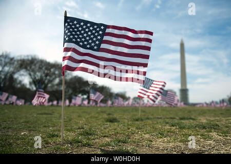 Some of the 1,892 American flags are seen on the National Mall placed by The Iraq and Afghanistan Veterans of America, each flag represents one of the 1,892 veterans and service members who have committed suicide this year, in Washington, D.C., March 27, 2014. The memorial is part of the 'We've Got Your Back: IAVA's Campaign to Combat Suicide  UPI/Kevin Dietsch Stock Photo