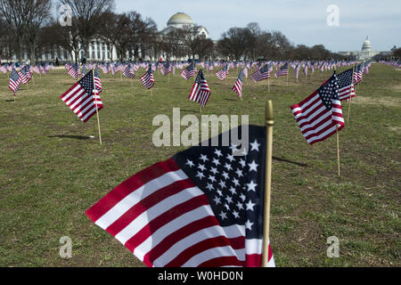 Some of the 1,892 American flags are seen on the National Mall placed by The Iraq and Afghanistan Veterans of America, each flag represents one of the 1,892 veterans and service members who have committed suicide this year, in Washington, D.C., March 27, 2014. The memorial is part of the 'We've Got Your Back: IAVA's Campaign to Combat Suicide  UPI/Kevin Dietsch Stock Photo