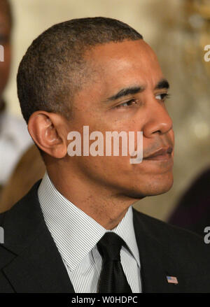 U.S. President Barack Obama pauses during a statement reacting to Republicans blocking a minimum wage bill in the Senate earlier in the day, in the East Room of the White House in Washington, DC on April 30, 2014.  The wage bill would have raised the minimum wage to $10.10 from $7.25 per hour over a number of years.  UPI/Pat Benic Stock Photo