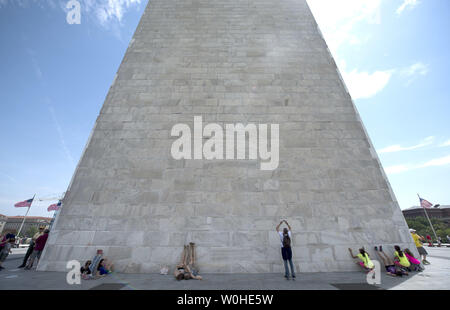 Tourist visit the Washington Monument as it is reopened after nearly three years of repairs and renovations following the 2011 earthquake, in Washington, D.C, May 12, 2014.  The Monument was closed following damages from the unusual 5.8 magnitude earthquake that hit the D.C. region. Cost to repair the monument were apoximatly $15 million, half of which was donated by philanthropist David Rubenstein. UPI/Kevin Dietsch Stock Photo