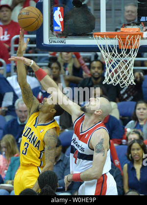 Indiana Pacers guard George Hill (3) shoots over Washington Wizards center Marcin Gortat (4) in game six of the Eastern Conference Semifinals at the Verizon Center in Washington, D.C. on May 15, 2014. The Pacers defeated the Wizards 93-80 and advance to the Eastern Conference finals. UPI/Kevin Dietsch Stock Photo