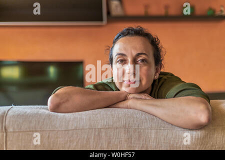 Pretty Spanish woman with glasses at home in front of the camera Stock Photo