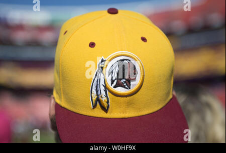 A member of the Washington Redskins maintenance staff takes down an inflatable  helmet with the Washington Redskins logo on it as the Redskins play the Chicago  Bears at FedEx Field in Landover