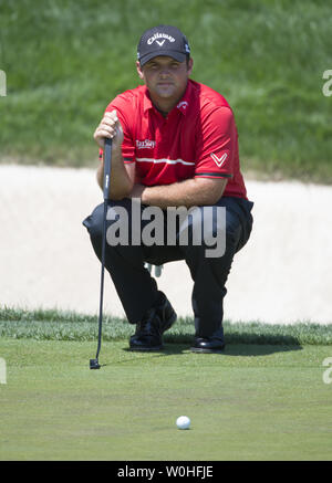 Patrick Reed lines up a putt on the 9th hole during the first round of ...
