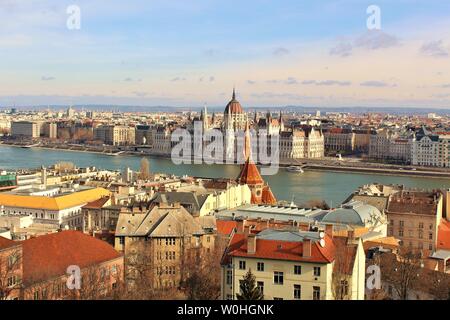 A view of the city of Budapest which is divided by the Danube river. In the centre is the Hungarian House of Parliament, which sits on the Pest side. Stock Photo