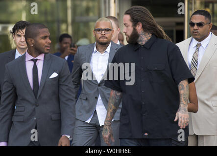 Entertainer Chris Brown (center) leaves the H. Carl Moultrie Courthouse in Washington, D.C. after pleading guilty to assault, September 2, 2014. Brown pleaded guilty to assaulting a man outside a Washington hotel last October and was sentenced to time served. Brown served two days in jail when originally arrested on the charges. UPI/Kevin Dietsch Stock Photo