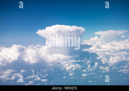 Beautiful giant Cumulonimbus, dense, towering vertical cloud forming from water vapor carried by powerful upward air currents from the airplane Stock Photo
