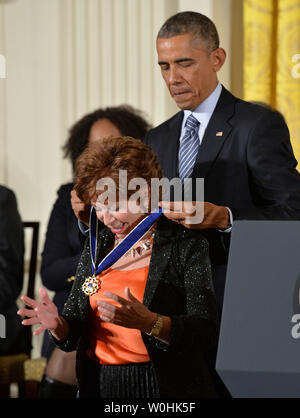 President Barack Obama awards author Isabel Allende a Presidential Medal of Freedom during a ceremony at the White House in Washington, D.C. on November 24, 2014. UPI/Kevin Dietsch Stock Photo