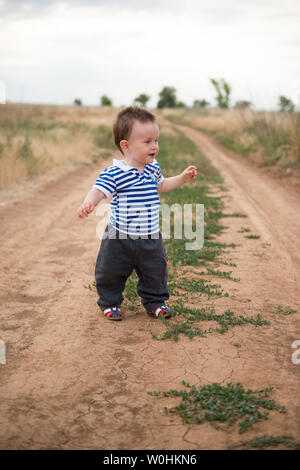 Baby's first steps in nature. The first independent steps. Stock Photo