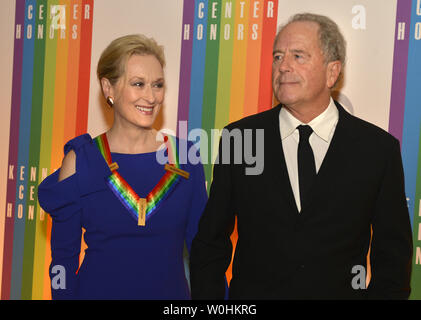 Actress Meryl Streep, a past Honoree (L) and her husband Don Gummer pose for photographers on the red carpet as they arrive for an evening of gala entertainment at the Kennedy Center, December 7, 2014, in Washington, DC.  The Kennedy Center Honors are bestowed annually on five artists for their lifetime achievement in the arts and culture.    UPI/Mike Theiler Stock Photo
