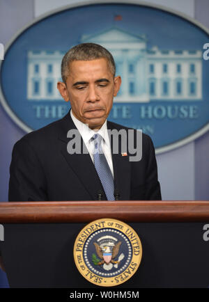 President Barack Obama pauses during an exchange with a reporter at a year-end press conference in the Brady Press Briefing Room at the White House on December 19, 2014.  Obama discussed various subjects including the Cuba, Sony, North Korea and the economy. The president will leave with his family to Hawaii later in the day for the holiday season.    UPI/Pat Benic Stock Photo