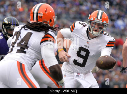 Cleveland Browns quarterback Connor Shaw hands off to Baltimore Ravens running back Lorenzo Taliaferro (34) against the Baltimore Ravens at M&T Bank Stadium in Baltimore, Maryland on December 28, 2014. The Ravens defeated the Browns 20-10. UPI/Kevin Dietsch Stock Photo