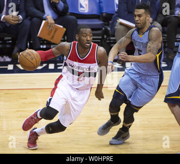 Washington Wizards guard John Wall (2) carries the ball against Memphis Grizzlies guard Courtney Lee (5) during the second quarter at the Verizon Center in Washington, D.C. on March 12, 2015. Photo by Kevin Dietsch/UPI Stock Photo