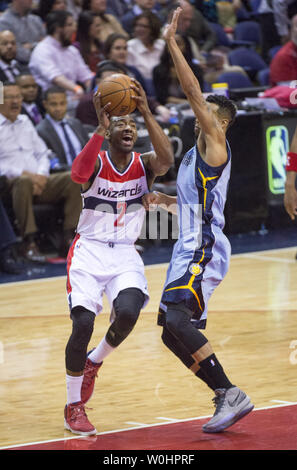 Washington Wizards guard John Wall drives to the basket against Memphis Grizzlies guard Courtney Lee during the first quarter at the Verizon Center in Washington, D.C. on March 12, 2015. Photo by Kevin Dietsch/UPI Stock Photo