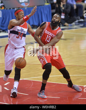 Houston Rockets guard James Harden (13) passes around Washington Wizards forward Paul Pierce (34) during the first quarter at the Verizon Center in Washington, D.C., March 29, 2015.  Photo by Kevin Dietsch/UPI Stock Photo