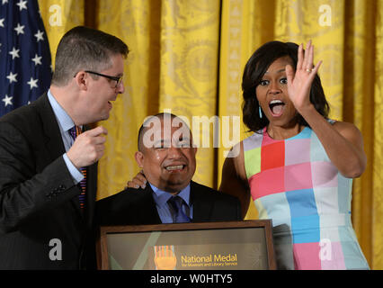 First Lady Michelle Obama reacts with Sergio Sanchez, community member of the Los Angeles Public Library, as she awards him and City Librarian John Szabo of the library the 2015 National Medal for Museum and Library Service during a ceremony in the East Room of the White House in Washington, DC on May 18, 2015.   The National Medal is the nation's highest honor given to museums and libraries for service to the community.   Photo by Pat Benic/UPI Stock Photo