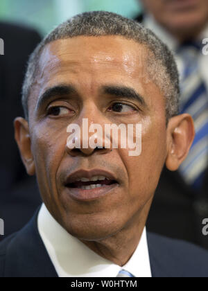 President Barack Obama delivers remarks before signing S. 665, the 'Rafael Ramos and Wenjian Liu National Blue Alert Act of 2015,' in the Oval Office at the White House in Washington, D.C. on May 19, 2015. The bill, named after New York City slain officers Ramos and Liu, orders the Department of Justice to establish a national Blue Alert communications network to disseminate information on:  the serious injury or death of a law enforcement officer in the line of duty; an officer who is missing in connection with the officer's official duties; or an imminent and credible threat that an individu Stock Photo