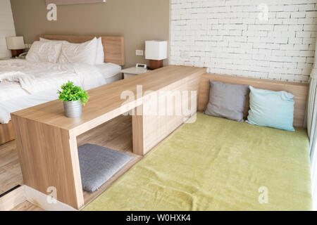 Khao Yai, Thailand - Apr 4 2016 : Bed wooden decorative interior soft tone at prairie hills resort Stock Photo