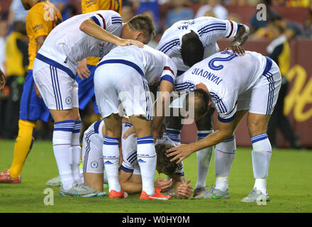 Chelsea defender Gary Cahill (24) is congratulated by teammates as he is injured after scoring a goal against Barcelona in the second half of their International Champions Cup match at FedEx Field in Landover, Maryland on July 28, 2015. Photo by Kevin Dietsch/UPI Stock Photo