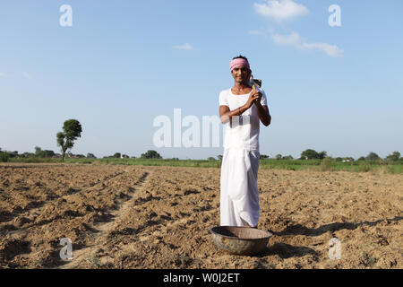 Indian farmer working in a field Stock Photo