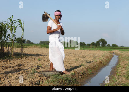Indian farmer working in a field Stock Photo