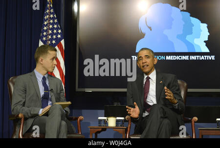 U.S.President Barack Obama makes remarks as The Atlantic moderator Dr. James Hamblin listens, during  a panel discussion at White House Precision Medicine Initiative (PMI) Summit, February 25, 2016, in Washington, DC. PMI aims to transform the way diseases like cancer and mental health conditions are treated.     Photo by Mike Theiler/UPI Stock Photo