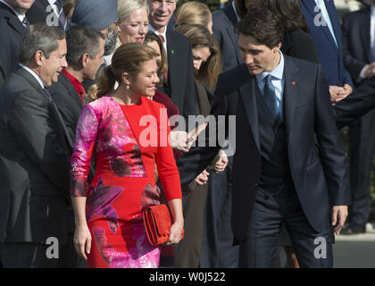 Canadian Prime Minister Justin Trudeau escorts his wife Sophie to her place during official welcoming ceremonies for the State Visit of the Canadian PM on the South Lawn of the White House in Washington, DC on March 10, 2016.       Photo by Pat Benic/UPI Stock Photo