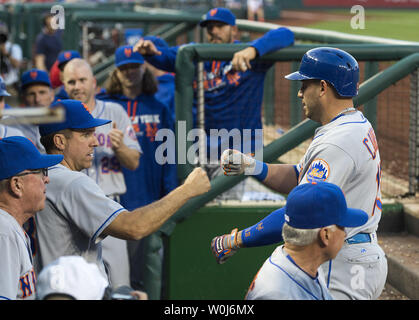 New York Mets shortstop Asdrubal Cabrera (R) is congratulated in the dugout after hitting a solo homer against the Washington Nationals in the fourth inning at Nationals Park in Washington, D.C. on May 24, 2016. Photo by Kevin Dietsch/UPI Stock Photo