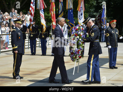 U.S.President Barack Obama (C) is assisted as he lays a wteath at the Tomb of the Unknown Soldier at Arlington National Cemetery, Arlington, Virginia, on Memorial Day, May 30, 2016, near Washington, DC. Obama paid tribute to the nation's military service members who have fallen.             Photo by Mike Theiler/UPI Stock Photo
