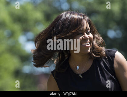 First Lady Michelle Obama smiles as she harvests the White House Kitchen Garden, in Washington, D.C. in Washington, D.C. on June 6, 2016. The First Lady invited school children from around the country to help harvest the garden and learn about healthy eating habits. Photo by Kevin Dietsch/UPI Stock Photo