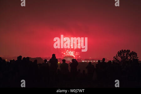 Spectators are silhouetted by the annual Independence Day firework display as they watch from Arlington, Virginia, on July 4, 2016. Photo by Kevin Dietsch/UPI Stock Photo