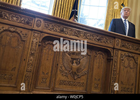 President Donald Trump is seen behind the Resolute Desk in the Oval Office at the White House during a swearing-in ceremony for Attorney General Jeff Sessions, in Washington, D.C. on February 9, 2017.  Photo by Kevin Dietsch/UPI Stock Photo