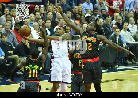 Washington Wizards guard Bradley Beal (3) shoots a basket against Atlanta Hawks forward Taurean Prince (12) and Tim Hardaway Jr. (10) at the Verizon Center in Washington, D.C. on April 19, 2017. Photo by Kevin Dietsch/UPI Stock Photo