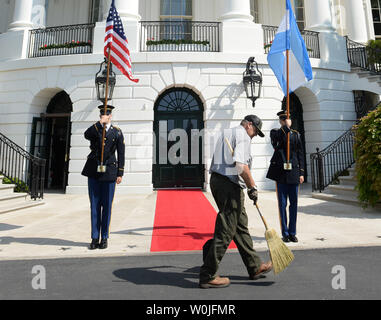 A worker cleans the driveway prior to the arrival of President Mauricio Macri and Mrs. Macri of Argentina for a visit with President Donald Trump, at the White House in Washington, D.C. on April 27, 2017. Photo by Pat Benic/UPI Stock Photo