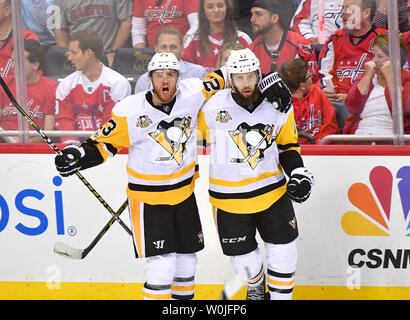 Pittsburgh Penguins center Nick Bonino (13) celebrates with Scott Wilson (23) after scoring against the Washington Capitals in the third period of the Eastern Conference Semifinals at the Verizon Center in Washington, D.C. on April 27, 2017. Photo by Kevin Dietsch/UPI Stock Photo