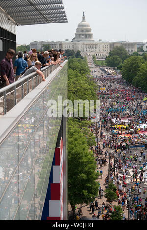 People gather on of the Newseum balcony to view the thousands gathered on Pennsylvania Ave for The Peoples Climate Movement in Washington D.C. April 29, 2017. They are marching to stand up for climate, jobs and justice and demand a new clean energy economy that creates good jobs and fights inequality and injustice. There are over 375 sister marches planned across the United States and around the world, from Japan to Brazil.          Photo by Ken Cedeno/UPI Stock Photo