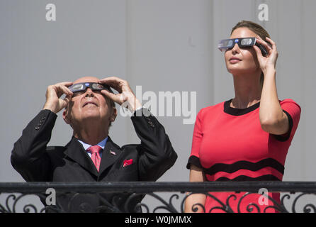 Ivan Trump, the daughter of President Donald Trump, and Secretary of Commerce Wilbur Ross wear special solar glasses as they view the solar eclipse from the White House in Washington, D.C. on August 21, 2017. Photo by Kevin Dietsch/UPI Stock Photo