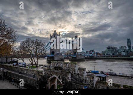 LONDON, ENGLAND, DECEMBER 10th, 2018: Tower Bridge in London, the UK. Sunrise with beautiful clouds. English symbols Stock Photo