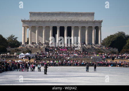 A large crowd fills up the reflecting pond in front of the Lincoln Memorial in Washington, D.C. on January 20, 2018. This is the one year anniversary of the Women's March where hundreds of thousands gathered in DC and all over the United States in support of women and to protest Donald Trump's election to President of the United States.     Photo by Ken Cedeno/UPI Stock Photo