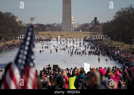 A large crowd fills up the reflecting pond in front of the Lincoln Memorial in Washington, D.C. on January 20, 2018. This is the one year anniversary of the Women's March where hundreds of thousands gathered in DC and all over the United States in support of women and to protest Donald Trump's election to President of the United States.     Photo by Ken Cedeno/UPI Stock Photo